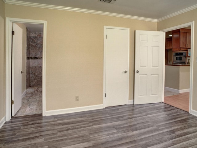 unfurnished bedroom featuring ornamental molding and dark hardwood / wood-style flooring