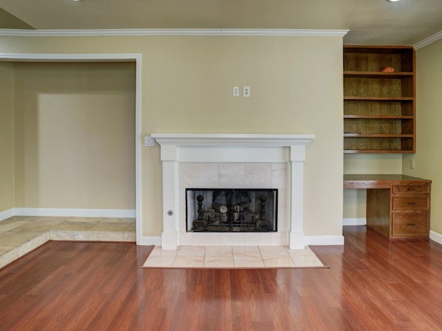 unfurnished living room with ornamental molding, light wood-type flooring, and a fireplace