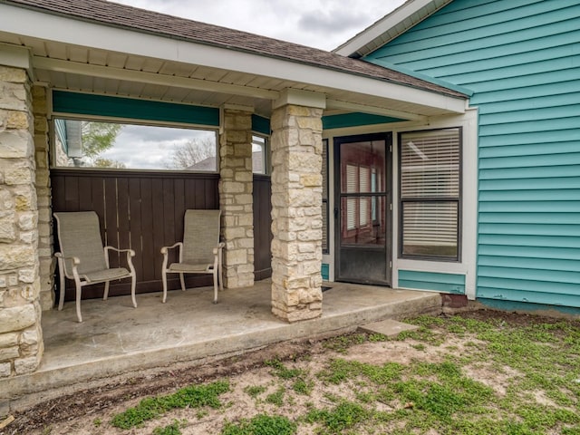 view of exterior entry featuring a patio