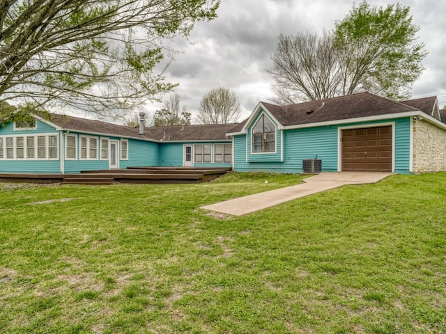 single story home with a front yard, a wooden deck, a garage, and central AC unit