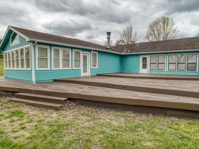 back of house featuring a wooden deck