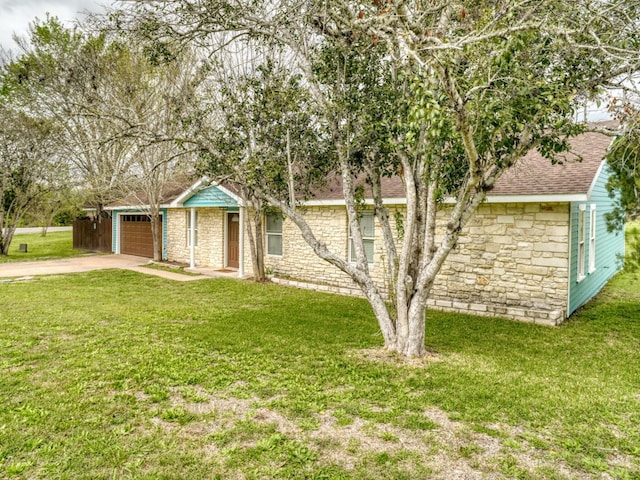 ranch-style home featuring a garage and a front lawn