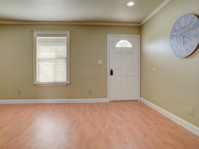 foyer featuring crown molding and light wood-type flooring