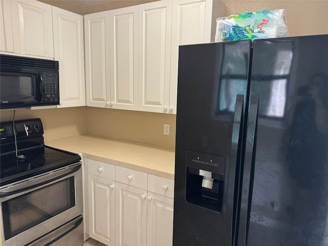 kitchen featuring white cabinets and black appliances