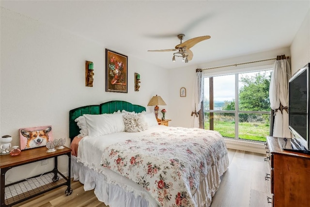 bedroom with light hardwood / wood-style floors and ceiling fan