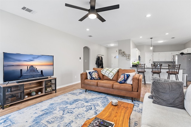 living room featuring light hardwood / wood-style flooring and ceiling fan