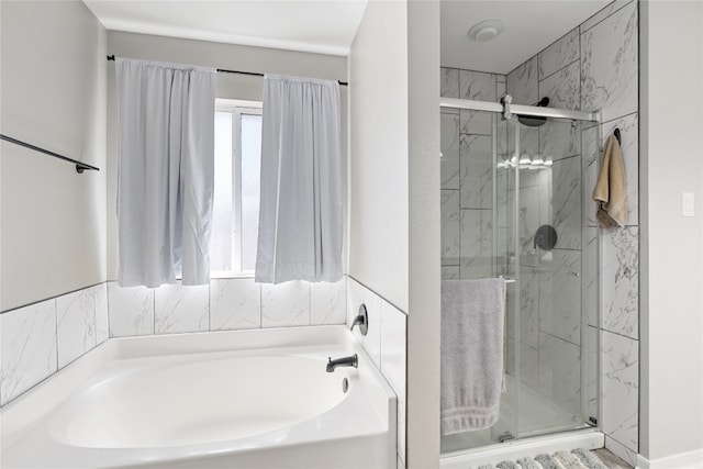 bathroom featuring separate shower and tub