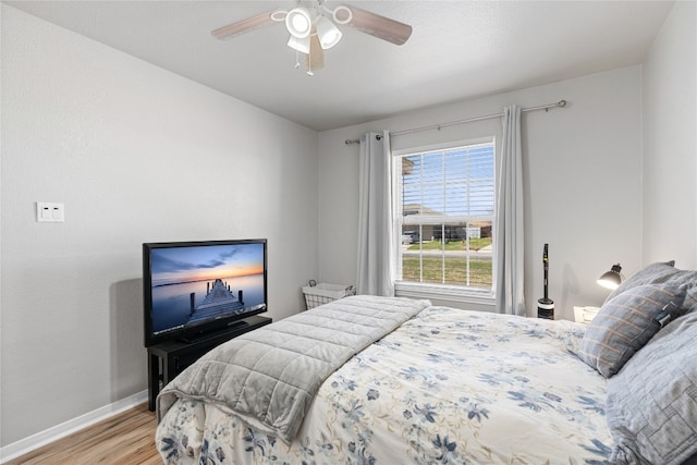 bedroom with ceiling fan and light wood-type flooring