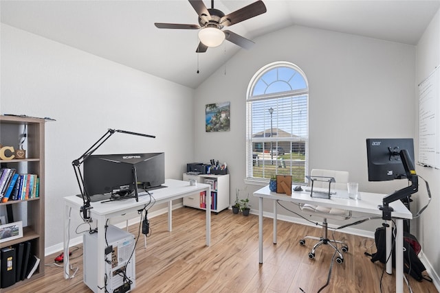 home office featuring light hardwood / wood-style floors, ceiling fan, and vaulted ceiling