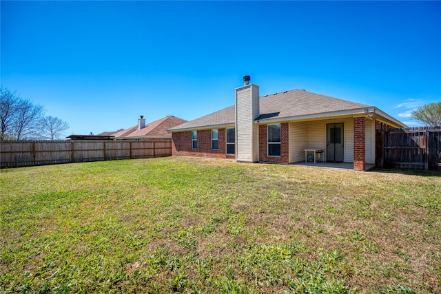 back of house featuring a yard and a patio