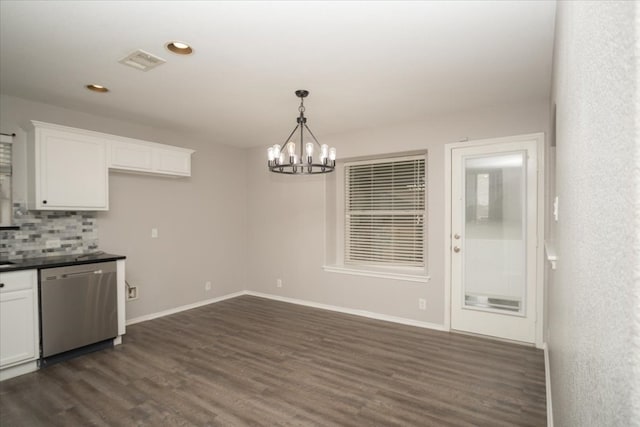 unfurnished dining area with an inviting chandelier and dark wood-type flooring