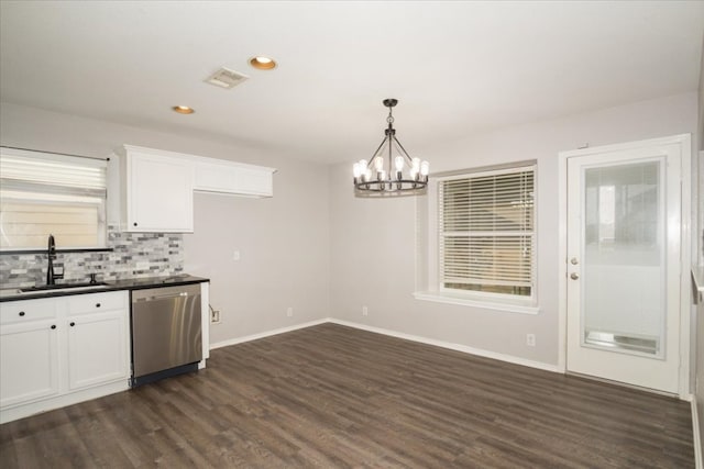 kitchen featuring stainless steel dishwasher, dark wood-type flooring, sink, white cabinets, and an inviting chandelier