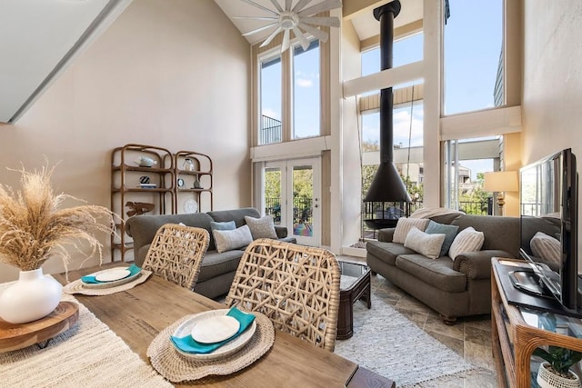 203 Venture Blvd S, Point Venture, TX 78645 - living room with a towering ceiling, a wood stove, and a ceiling fan