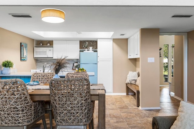 203 Venture Blvd S, Point Venture, TX 78645 - dining area featuring baseboards and a skylight