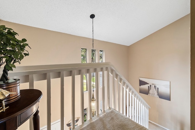 stairway with lofted ceiling and carpet