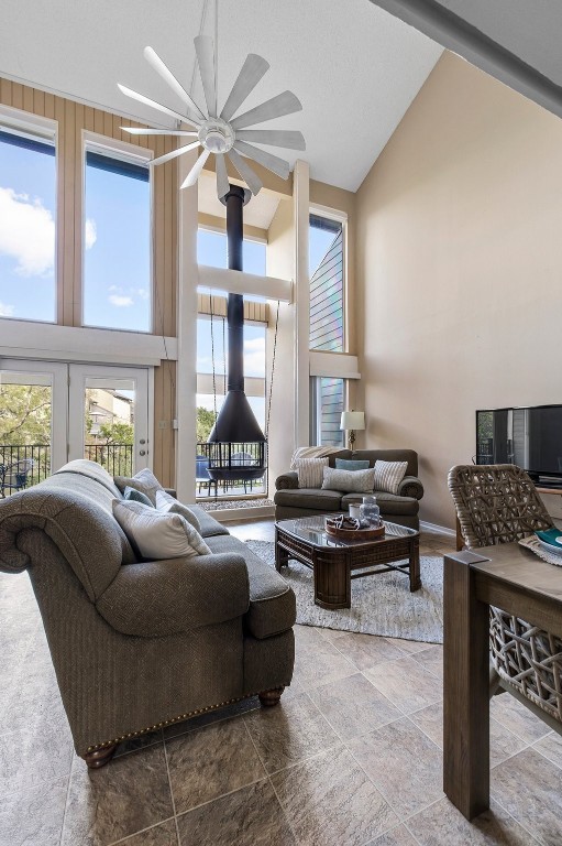 living room featuring high vaulted ceiling and ceiling fan