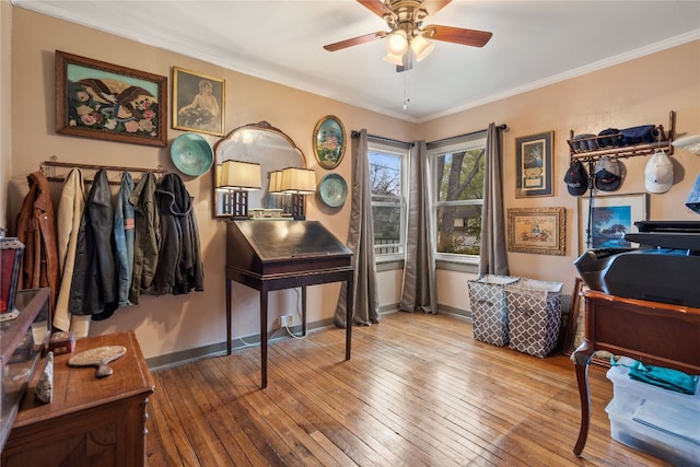 office space with crown molding, wood-type flooring, and ceiling fan