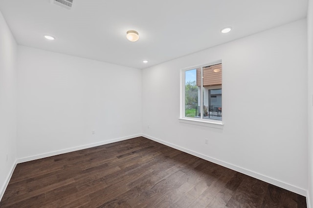 unfurnished room with dark wood-type flooring