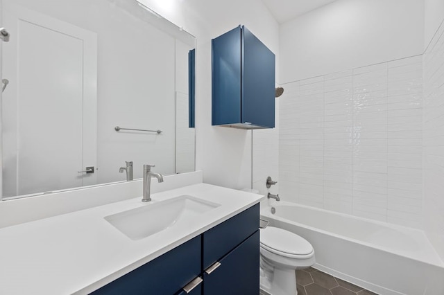 full bathroom with tile patterned flooring, tiled shower / bath, vanity, and toilet