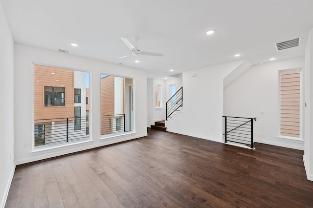 unfurnished living room with dark wood-type flooring and ceiling fan