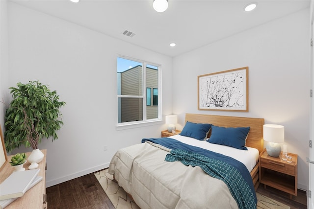 bedroom with dark hardwood / wood-style flooring