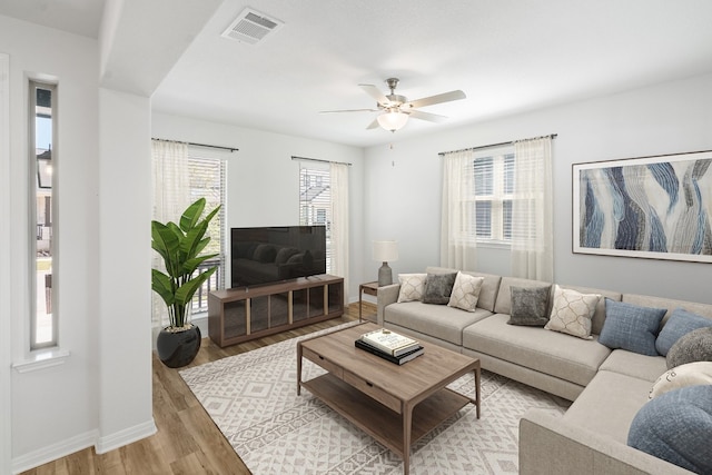 living room with ceiling fan and light wood-type flooring