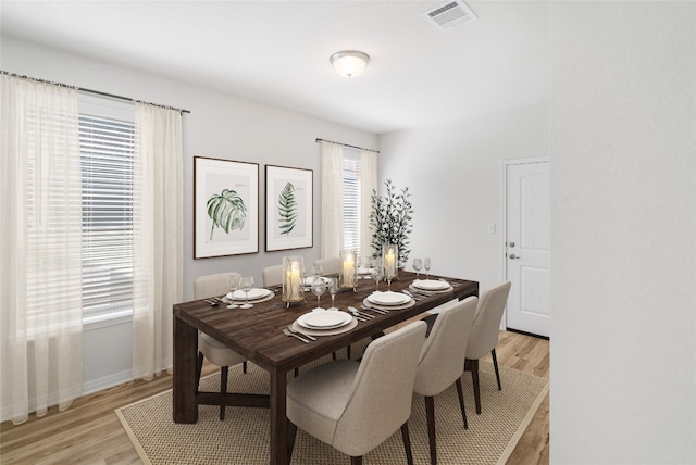 dining area featuring plenty of natural light and light hardwood / wood-style flooring