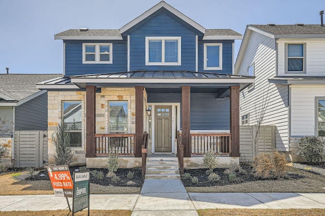 view of front of home with a standing seam roof, a porch, and metal roof