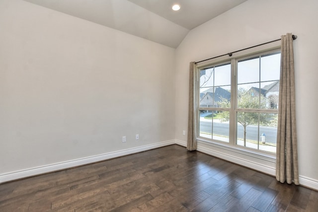 empty room featuring lofted ceiling and dark hardwood / wood-style floors