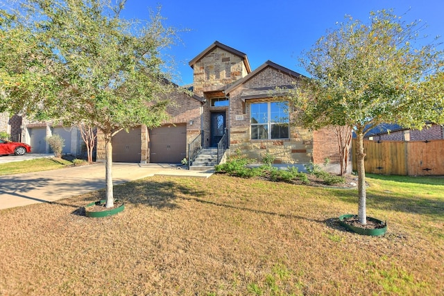 view of front of house with a front yard and a garage