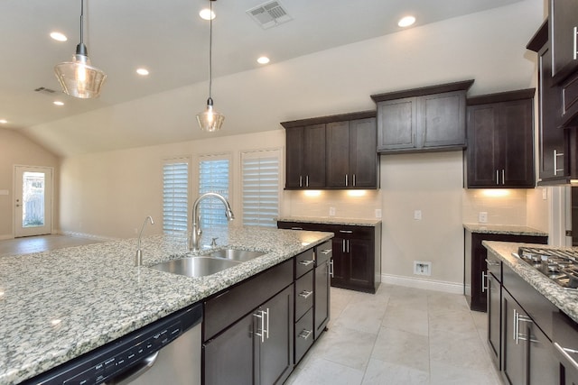 kitchen with light tile flooring, backsplash, appliances with stainless steel finishes, and sink