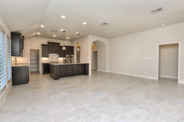 kitchen featuring backsplash, decorative light fixtures, vaulted ceiling, and light tile floors