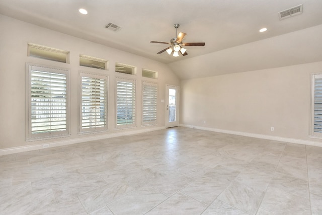 tiled spare room with lofted ceiling, plenty of natural light, and ceiling fan