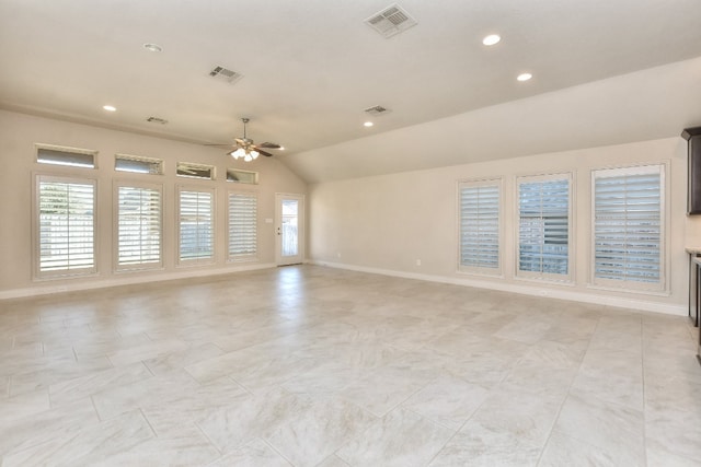 tiled empty room featuring plenty of natural light, vaulted ceiling, and ceiling fan