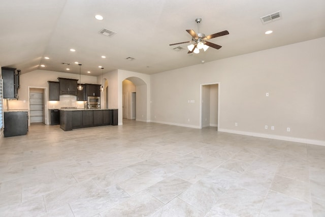 unfurnished living room with vaulted ceiling, light tile flooring, and ceiling fan