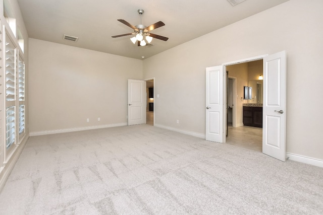 unfurnished bedroom featuring light carpet and ceiling fan