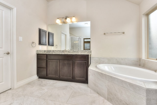 bathroom with vanity, tile flooring, and tiled tub