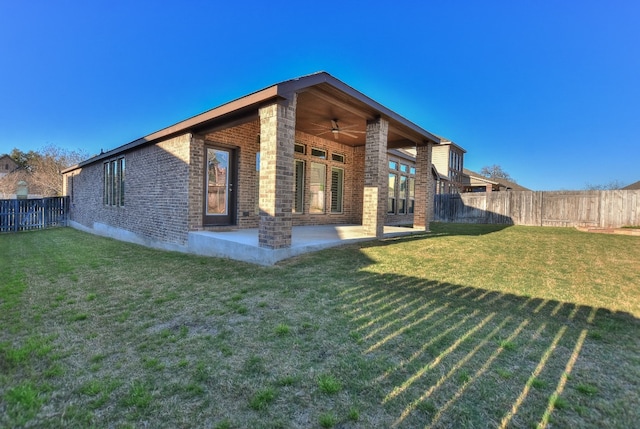 rear view of house featuring a patio area, a lawn, and ceiling fan