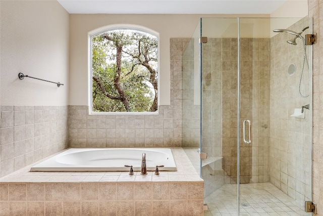 bathroom featuring shower with separate bathtub