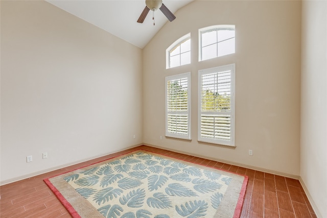 spare room with vaulted ceiling, ceiling fan, and light wood-type flooring