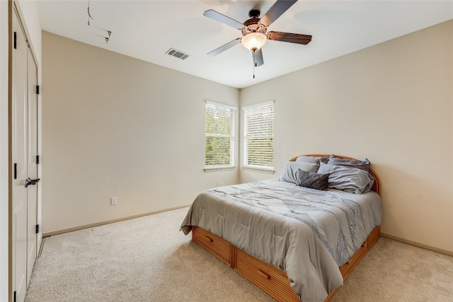 bedroom with light carpet and ceiling fan