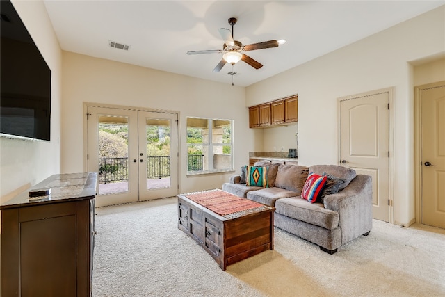 living room with light carpet, ceiling fan, and french doors