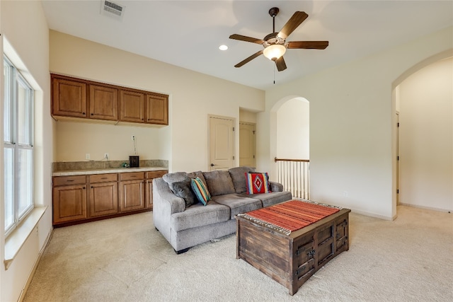 living room featuring ceiling fan and light carpet