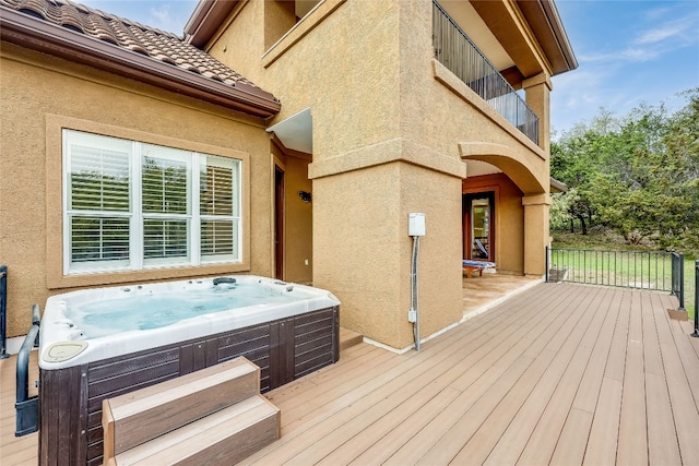 wooden deck with a hot tub