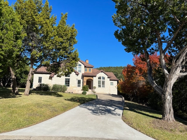 mediterranean / spanish-style home with a front yard