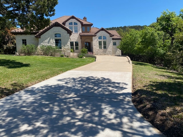 mediterranean / spanish-style home featuring a front yard