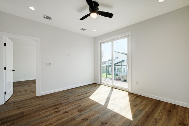 empty room with ceiling fan and dark wood-type flooring