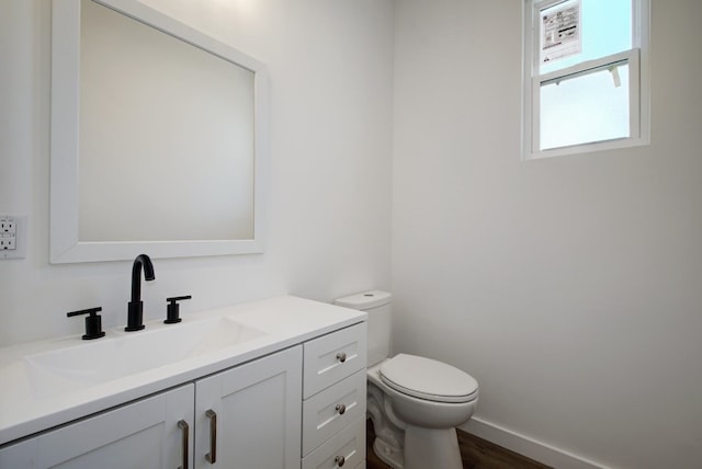 bathroom featuring oversized vanity and toilet