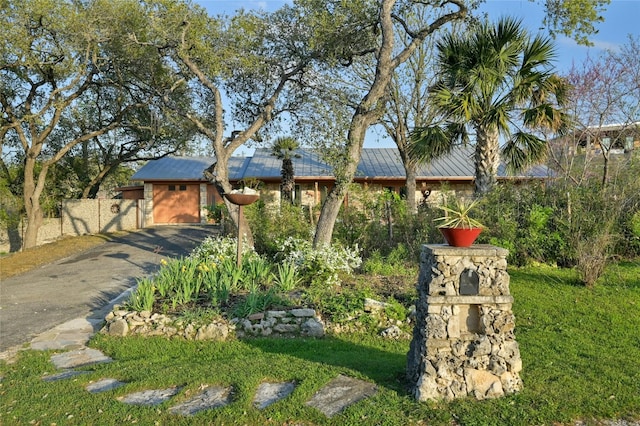 view of front of property with solar panels and a front lawn