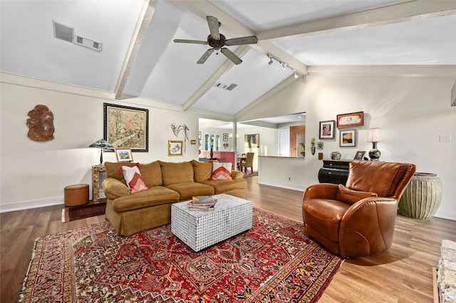 living room featuring high vaulted ceiling, ceiling fan, wood-type flooring, and beam ceiling